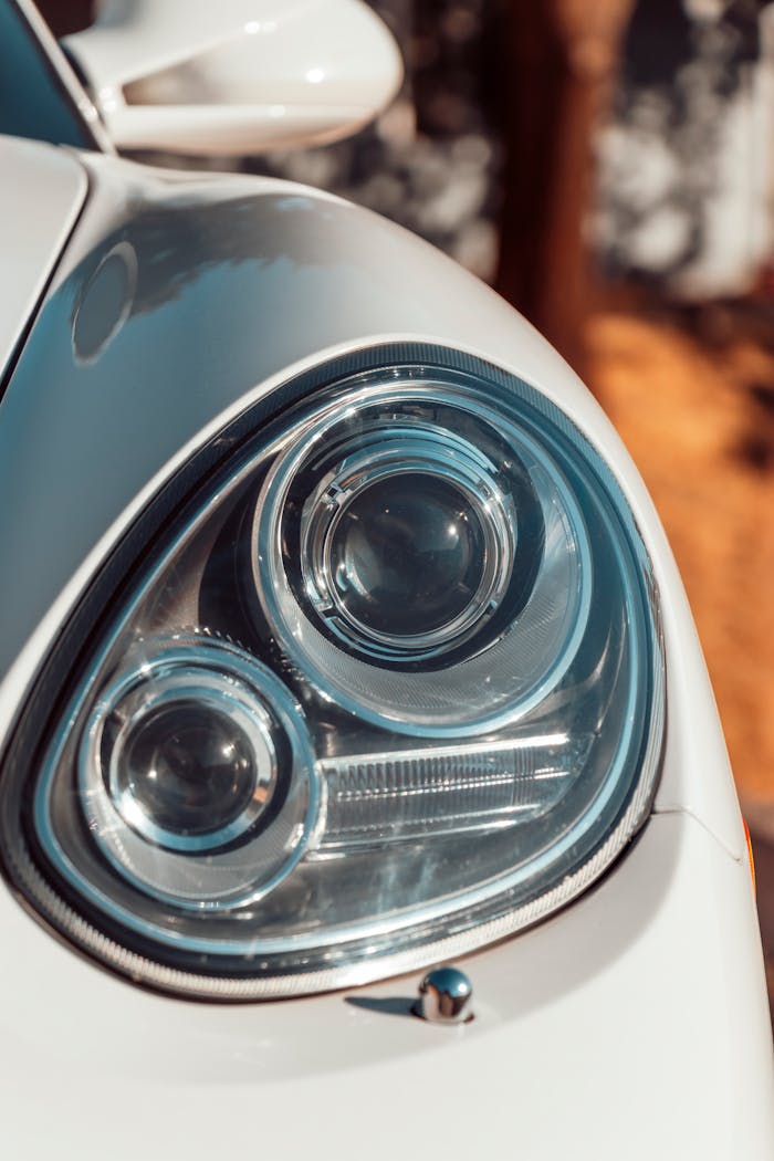 Detailed close-up of a classic car's headlight showcasing chrome design and style.