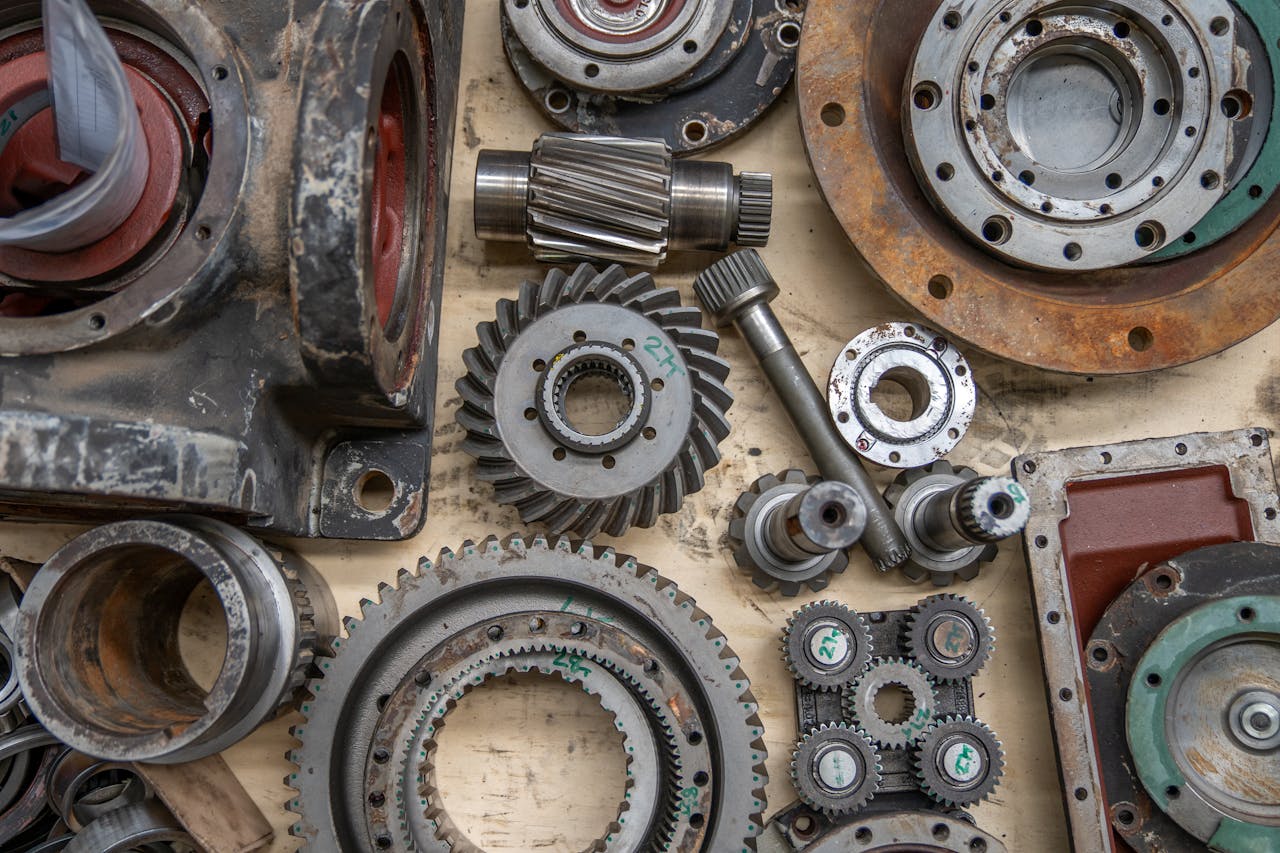 Detailed shot of industrial gears and mechanical parts in a workshop setting.